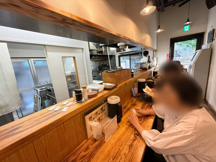 木のカウンターを中心にした井上商店の店内