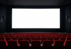 誰もいない映画館の客席と光るスクリーン