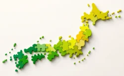 日本地図をモチーフにした抽象的なパズルピース、緑と黄色のグラデーション