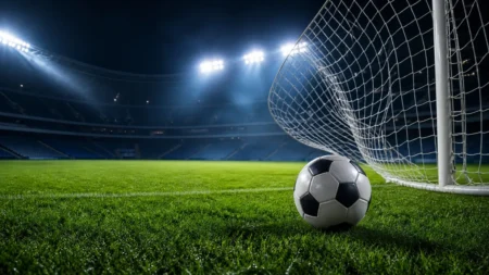 緑のピッチとゴールネットを思わせる躍動的なサッカーの情景