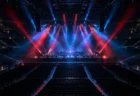 青と赤のライトが交差する開演前のアリーナのステージ