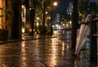 雨上がりの夜の街、濡れた舗道に映るネオンと傘