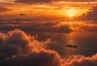 夕焼けの雲海の上空を飛ぶ戦闘機と、海上を進む空母のシルエット