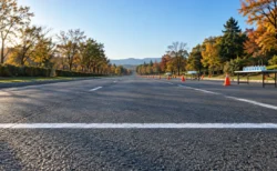 秋晴れの朝の舗装路に引かれたスタートラインと給水テーブル