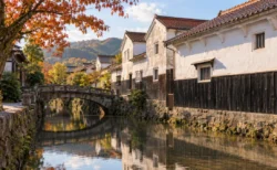 秋の午後の倉吉の白壁土蔵群と玉川にかかる石橋