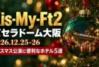 Kis-My-Ft2 京セラドーム大阪 2026.12.25-26 クリスマス公演に便利なホテル5選の文字と、モミの枝に下がる緑のガラスのオーナメントに夜の街と電車が映り込む写真風の画像