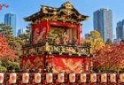 秋晴れの都市公園に展示された金色の装飾の山車と提灯