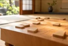 朝の光が差し込む和室に置かれた将棋盤と駒