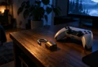 暗い部屋の机に置かれたゲーム機のコントローラーと、そばに置かれた小さな南京錠