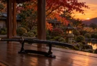 夕暮れの日本家屋の縁側に置かれた刀掛けと、庭の紅葉
